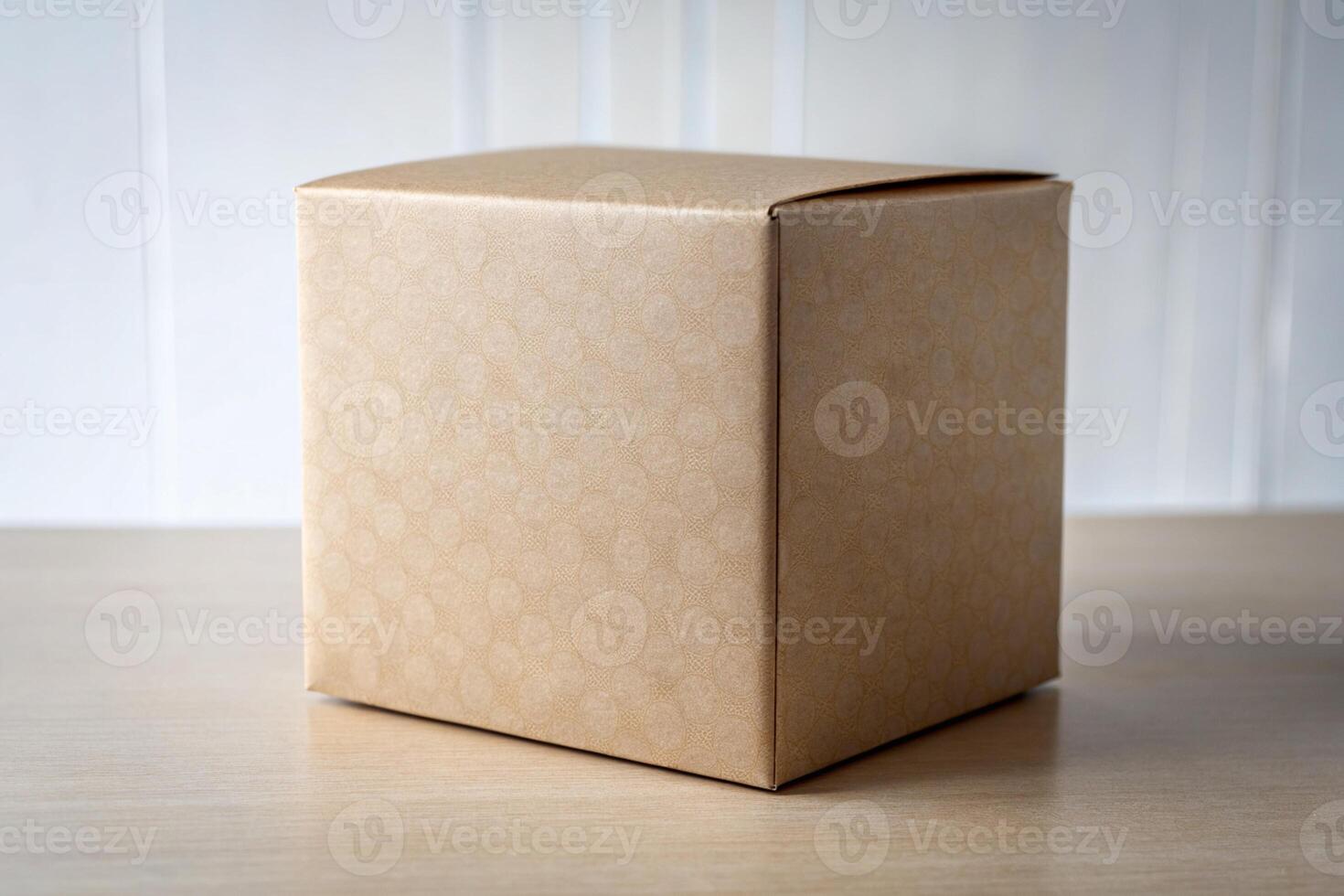 Brown cardboard box on a wooden table in front of a white wall photo