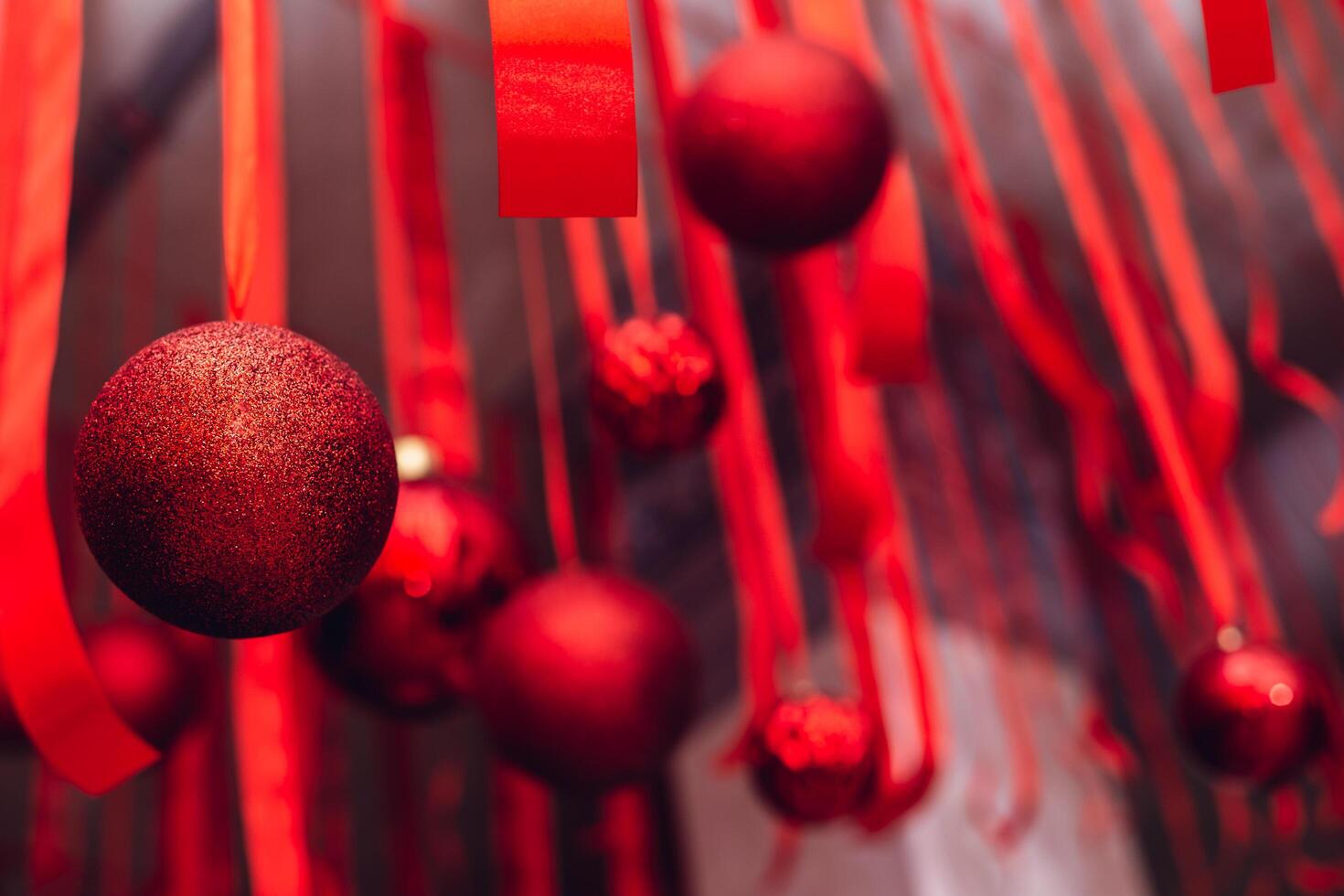 Beautiful Christmass and New Year decoration - red shiny ribbons and balls. photo