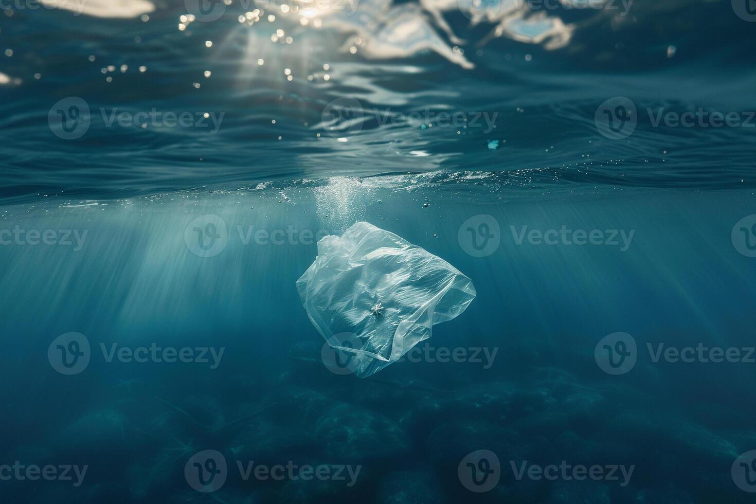 Plastic bag floating under the water in the ocean. photo