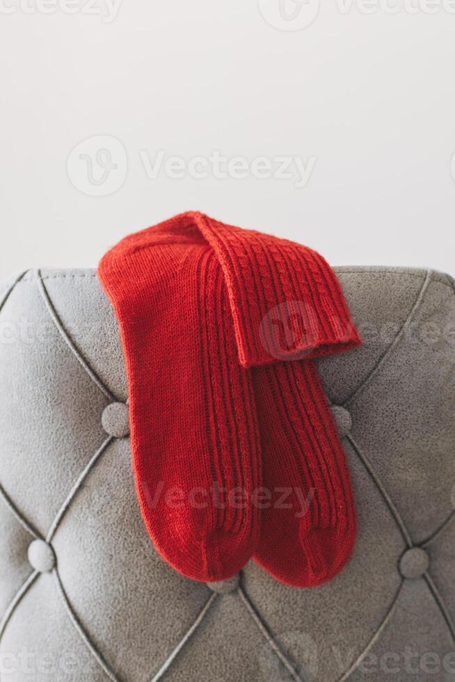 Hand knitted socks on a grey background. Concept for handmade and hygge slow life. photo