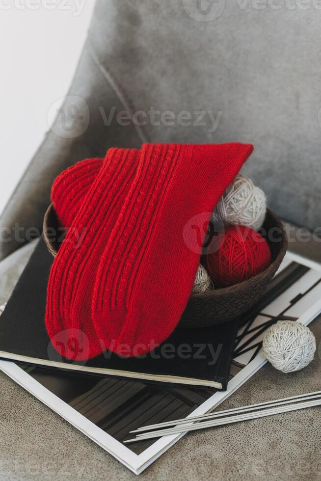Hand knitted socks with needles and yarn ball. Concept for handmade and hygge slow life. photo