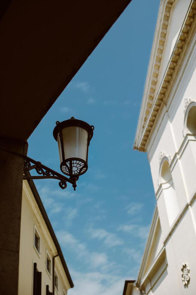 Beautiful old street in Padova, Italy. Amazing blue sky. photo