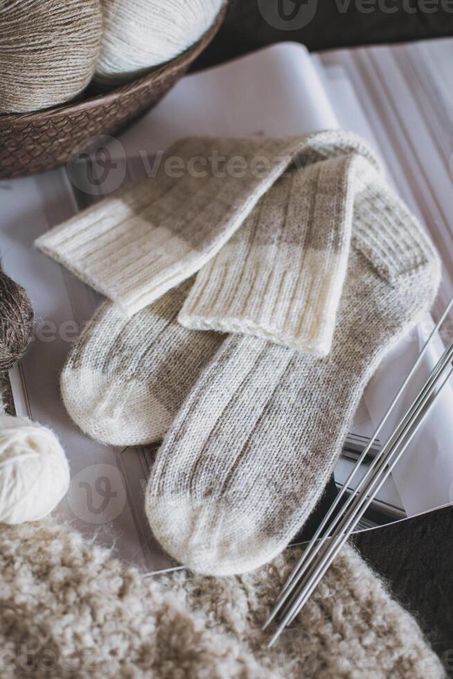 Hand knitted socks with needles and yarn ball. Concept for handmade and hygge slow life. photo