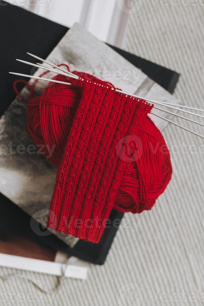 Hand knitted socks with needles and yarn ball. Concept for handmade and hygge slow life. photo