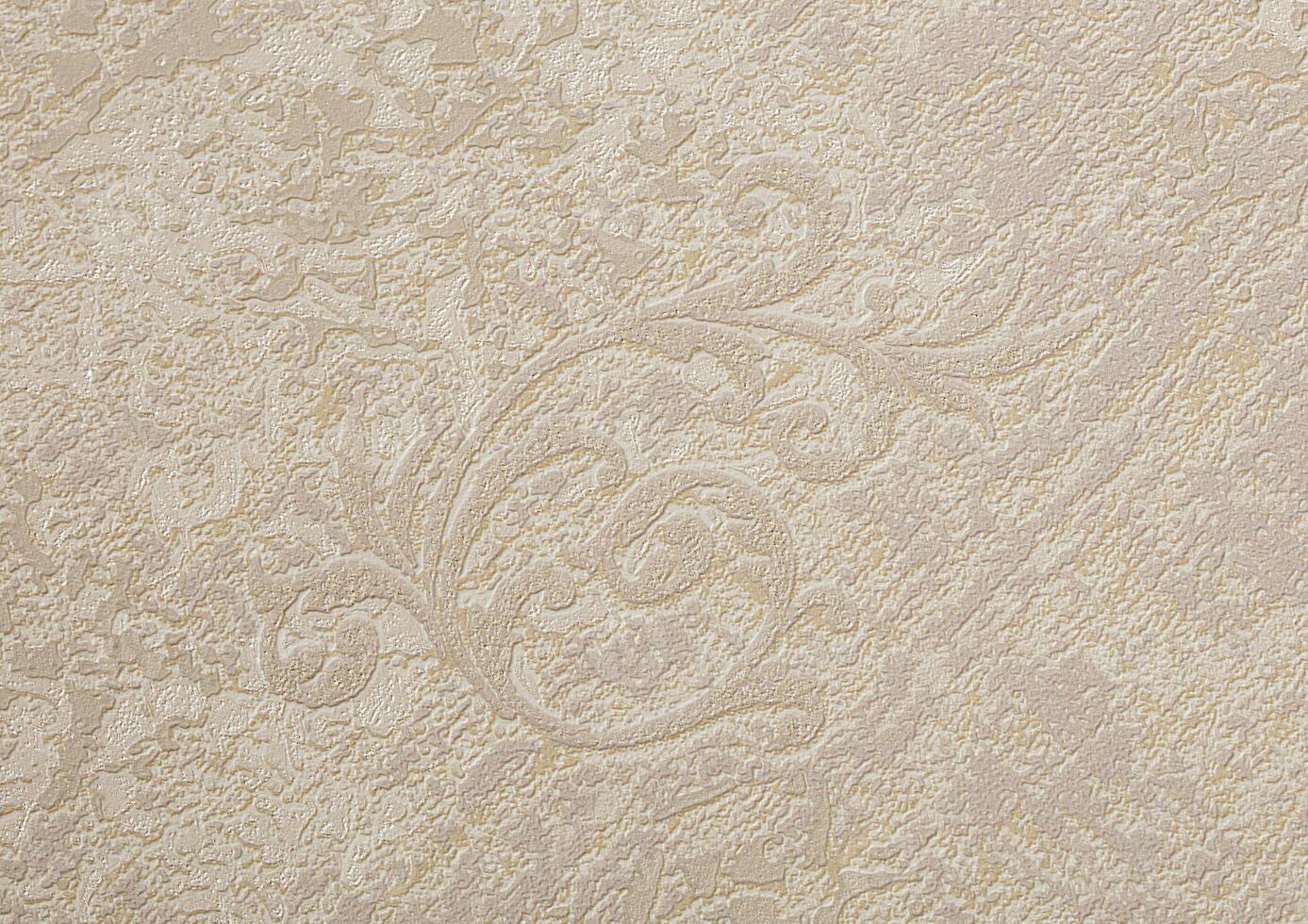 Background of beige wallpaper or plaster wall with vintage swirl pattern. photo