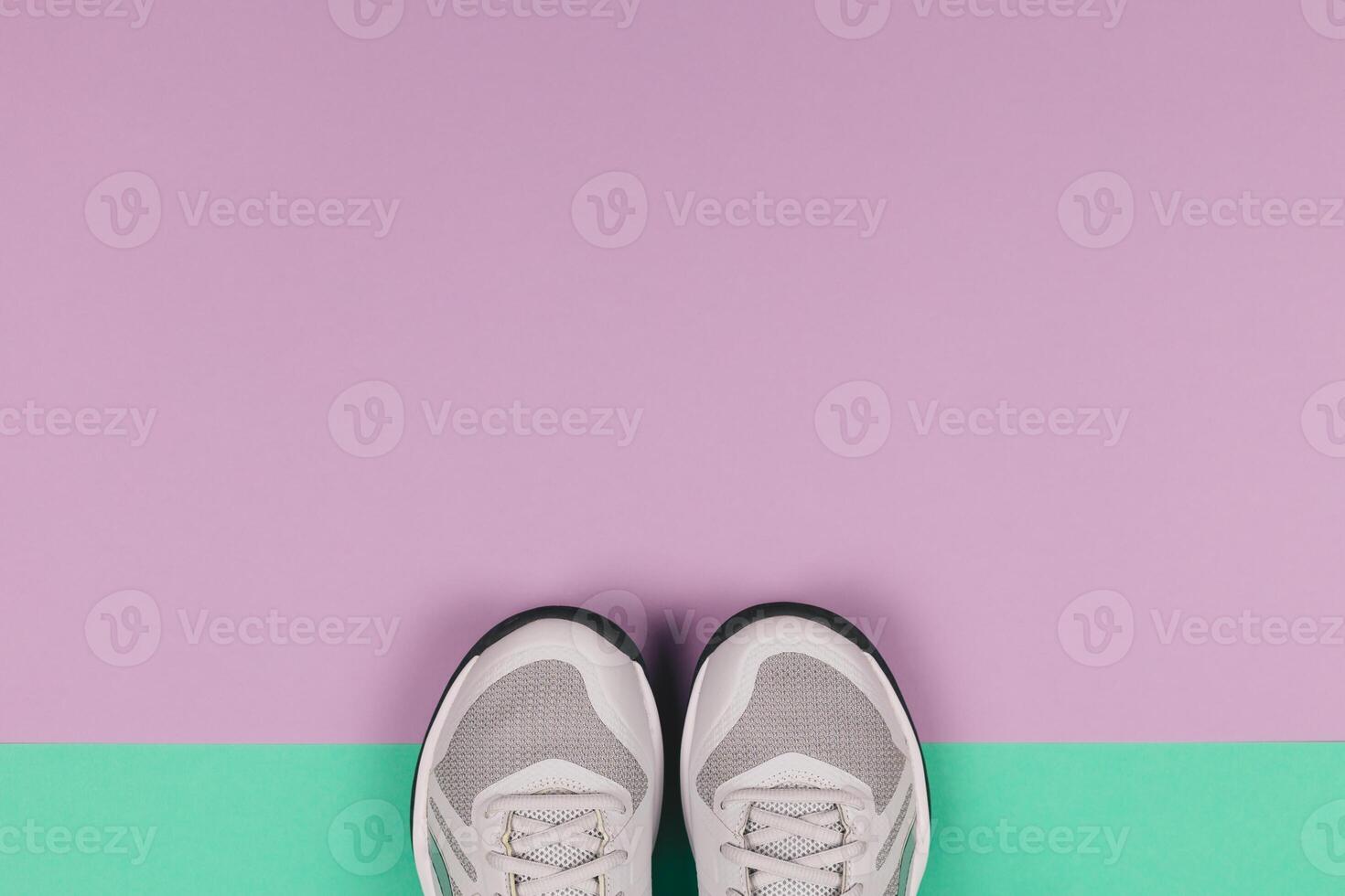 Grey sneakers on the violet and turquoise background. Concept for healthy lifestyle and everyday training. photo