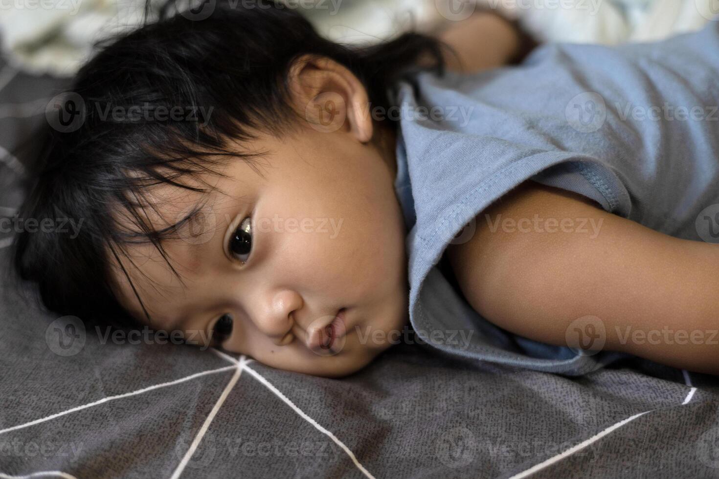 Little Boy Lying Down On The Bed photo