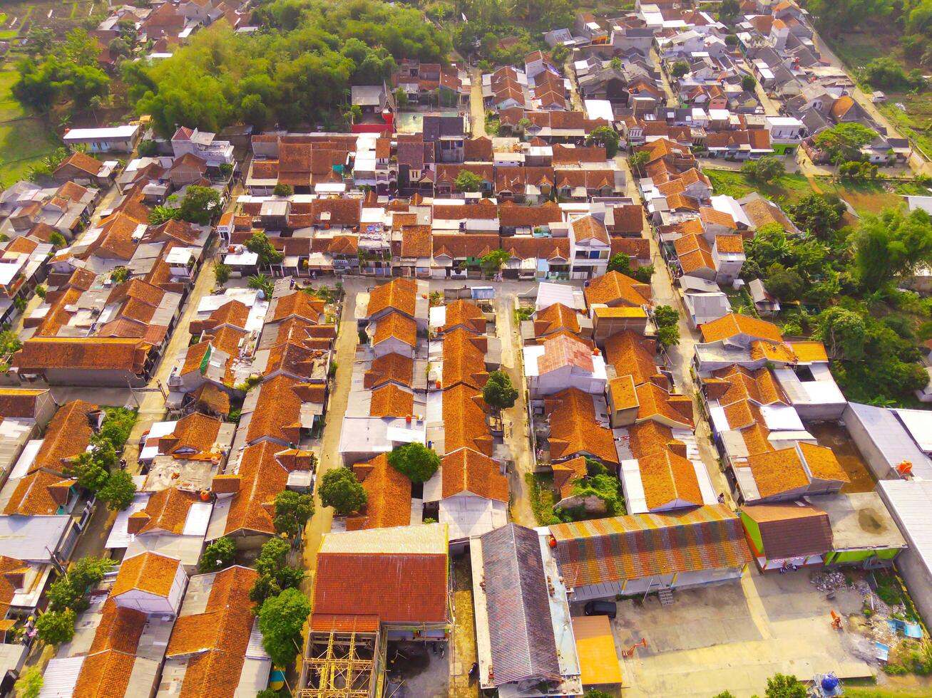 Aerial of Houses in Bandung Suburbs. An aerial view taken from a drone of a large housing estate in Bandung, Indonesia. Many similar houses in a dense development. photo