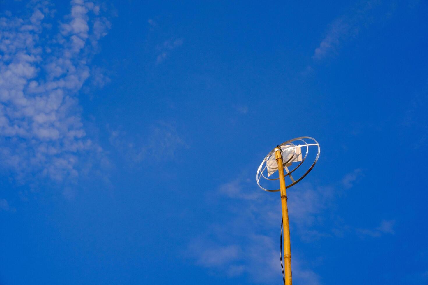 Landscape Photography. Landscape View. TV antenna with bamboo pole. A TV antenna with a blue sky background. Bandung, Indonesia photo