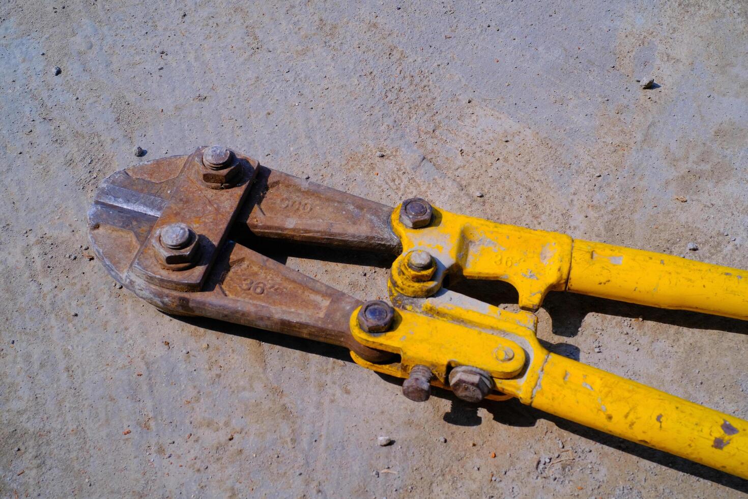 Industrial Photography. Construction Tools. Isolated Iron bar cutting scissors. A bar iron cutting tool owned by a builder. Bandung, Indonesia photo