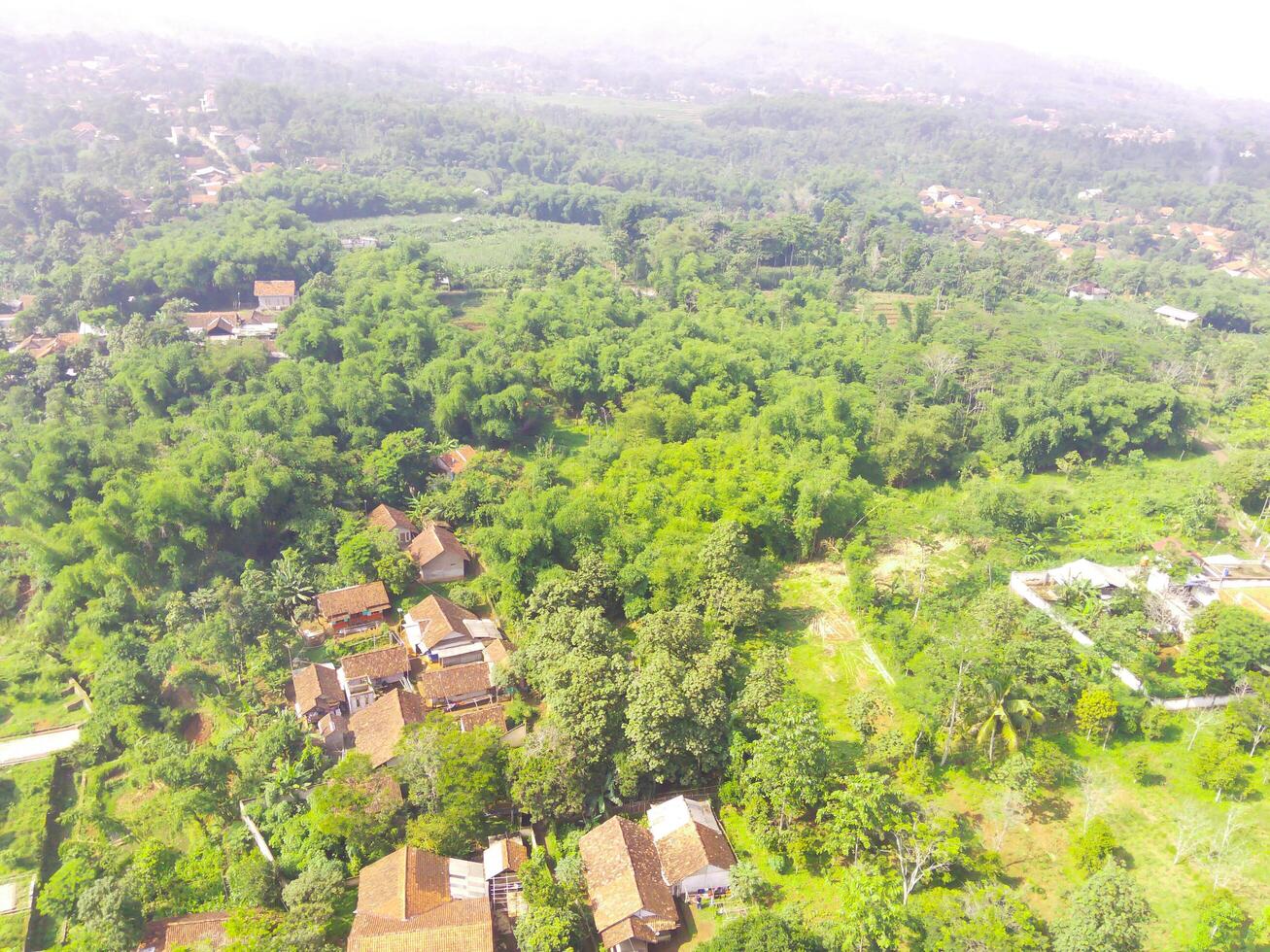 Bird eye view of tropical forest on the edge of the city, forest that functions as a water catchment in the city of Bandung, West Java Indonesia, Asia. Natural Landscape. Top view. Aerial Shot photo