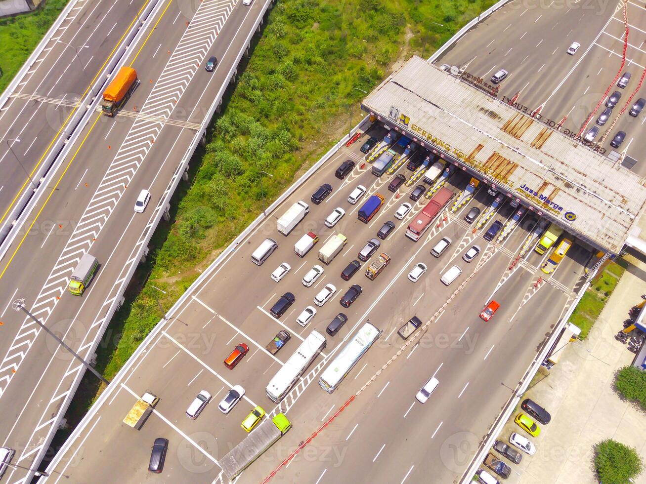 Bird eye view of Vehicle queue at the Purbaleunyi toll gate, due to the surge in travelers during the holiday season, Bandung, West Java Indonesia, Asia. Transportation Industry. Top view. Aerial Shot photo