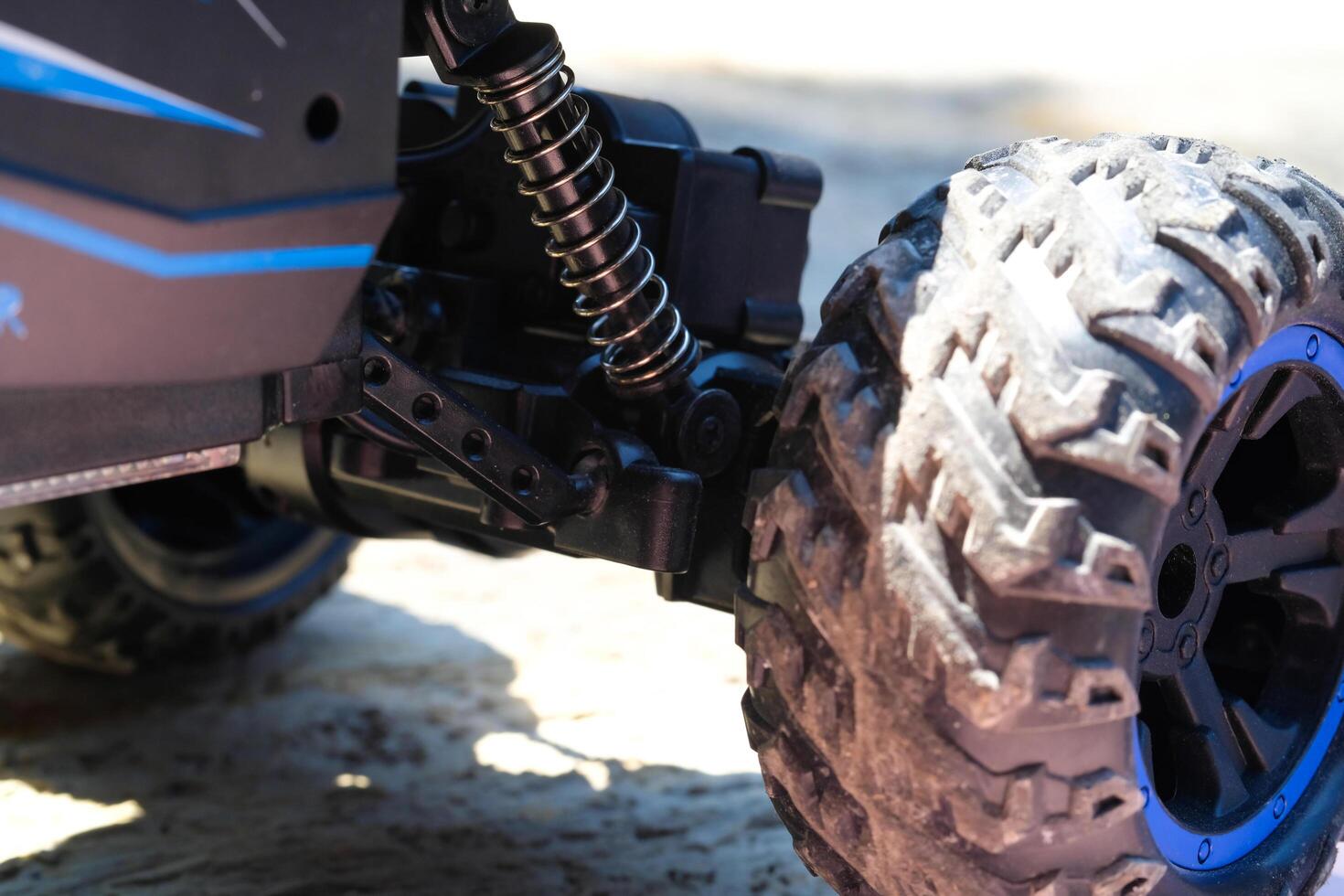 Toys Photography. Closeup Toys. Macro photo of RC Remote Control Car from the side view. There are lights, car wheels, suspension and bumpers. Shot with a macro lens