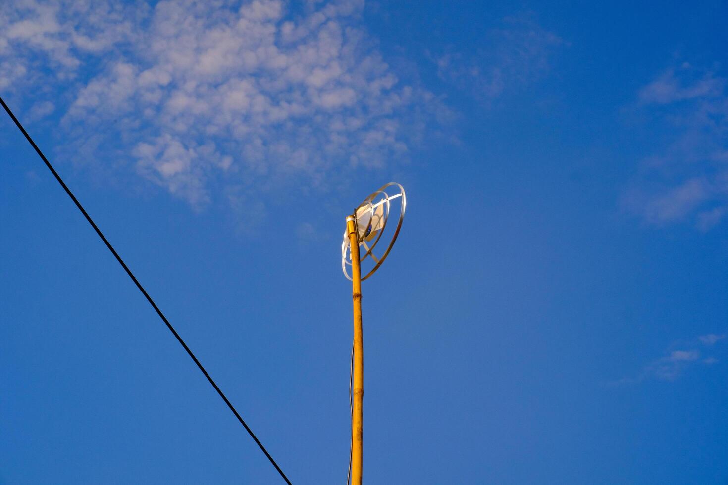 Landscape Photography. Landscape View. TV antenna with bamboo pole. A TV antenna with a blue sky background. Bandung, Indonesia photo