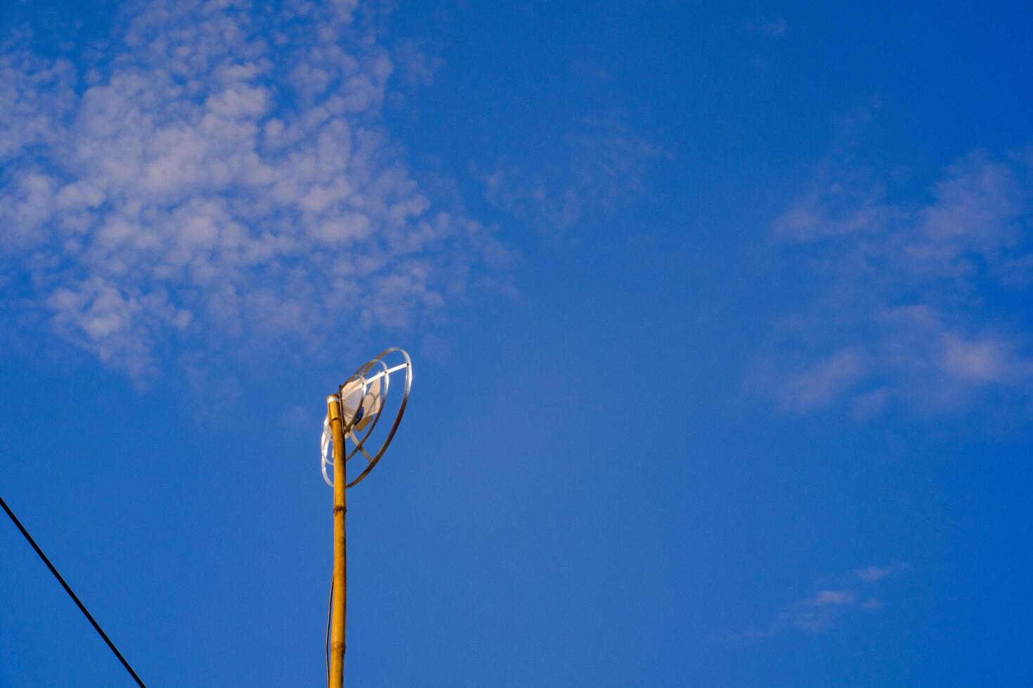 Landscape Photography. Landscape View. TV antenna with bamboo pole. A TV antenna with a blue sky background. Bandung, Indonesia photo