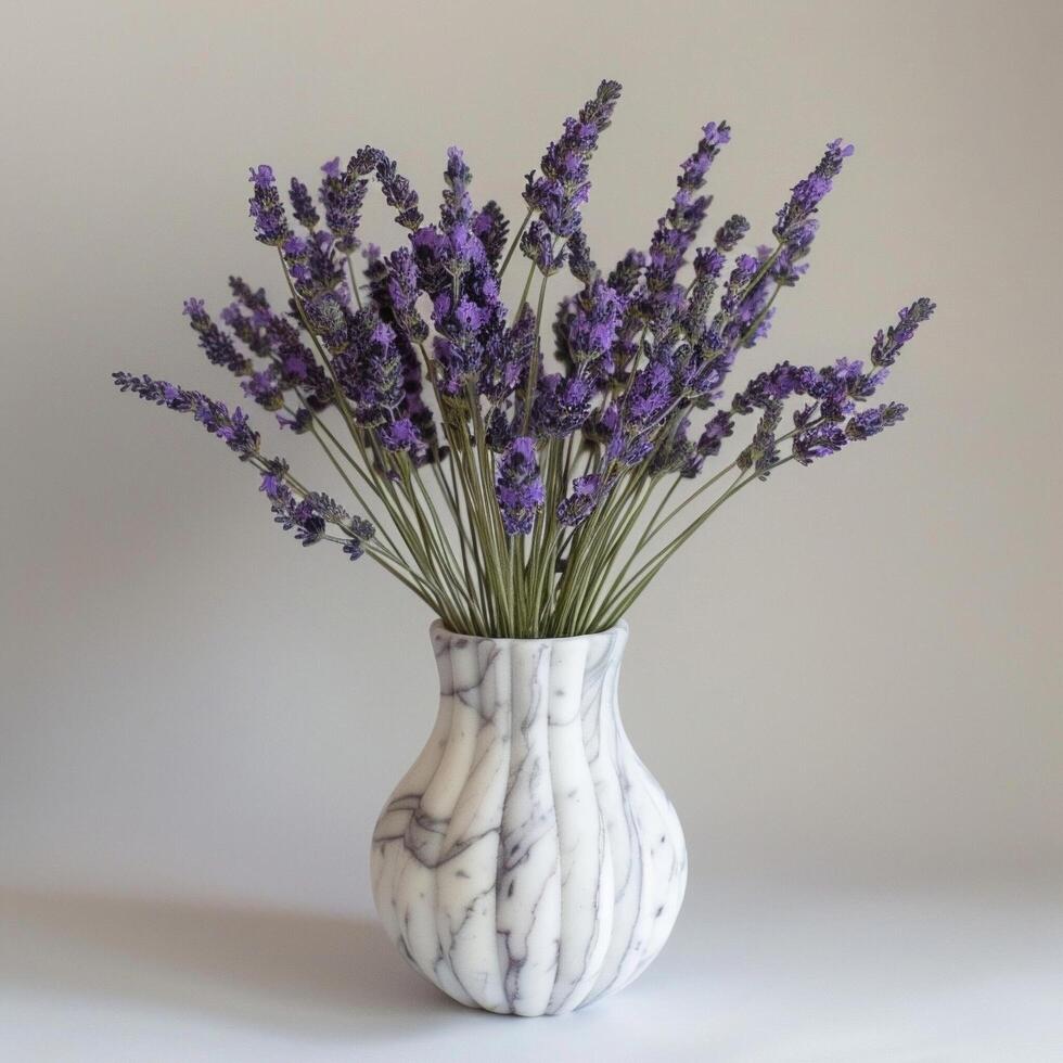 A sleek marble vase holds a bouquet of fragrant lavender flowers. photo