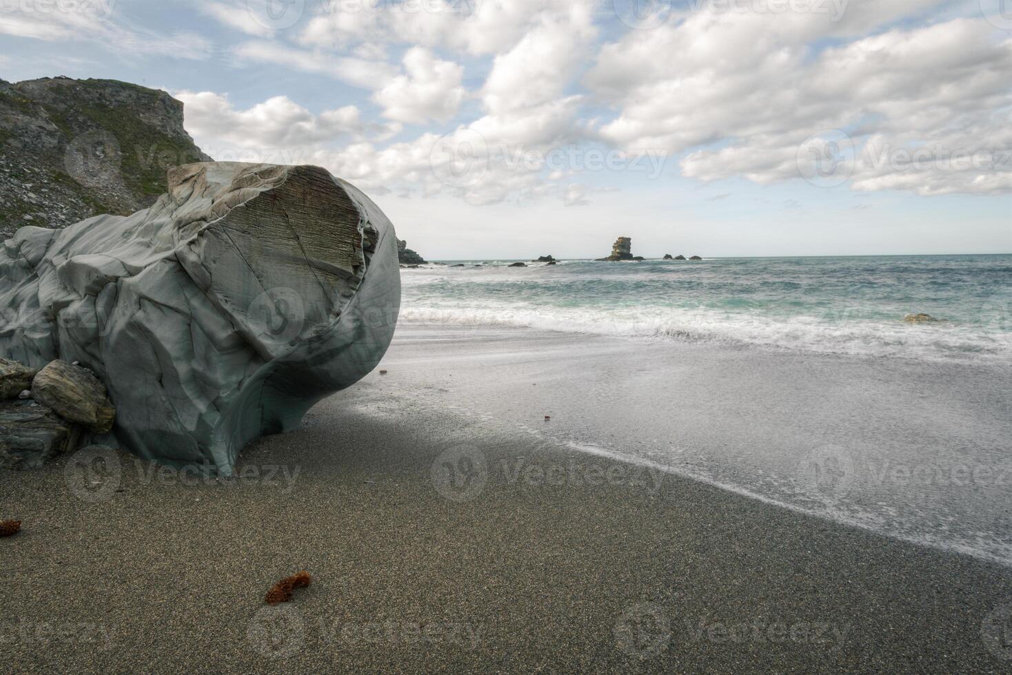 Surprising erosion in a very hard block of pure quartz on a beach photo