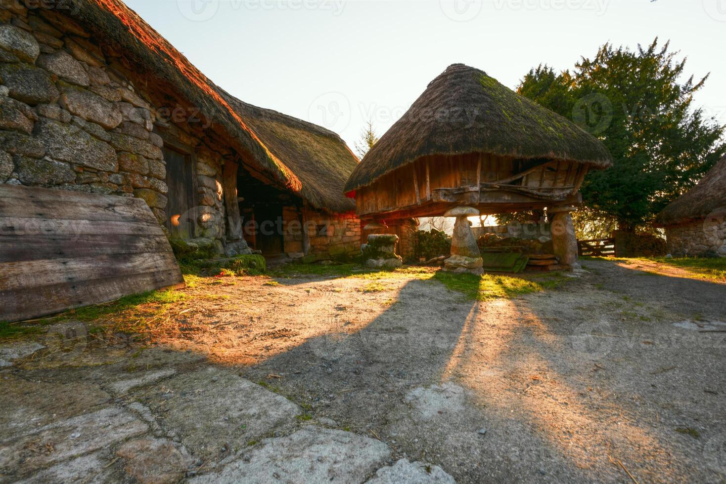 The evening light between the granaries and pallozas of Piornedo photo
