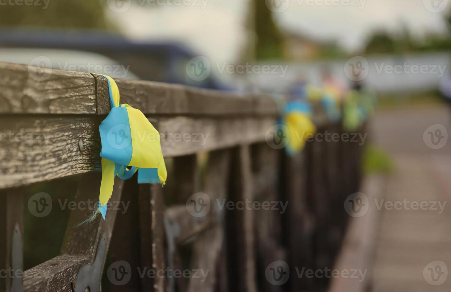 Ribbons in the colors of the national flag of Ukraine are tied to the handrail photo