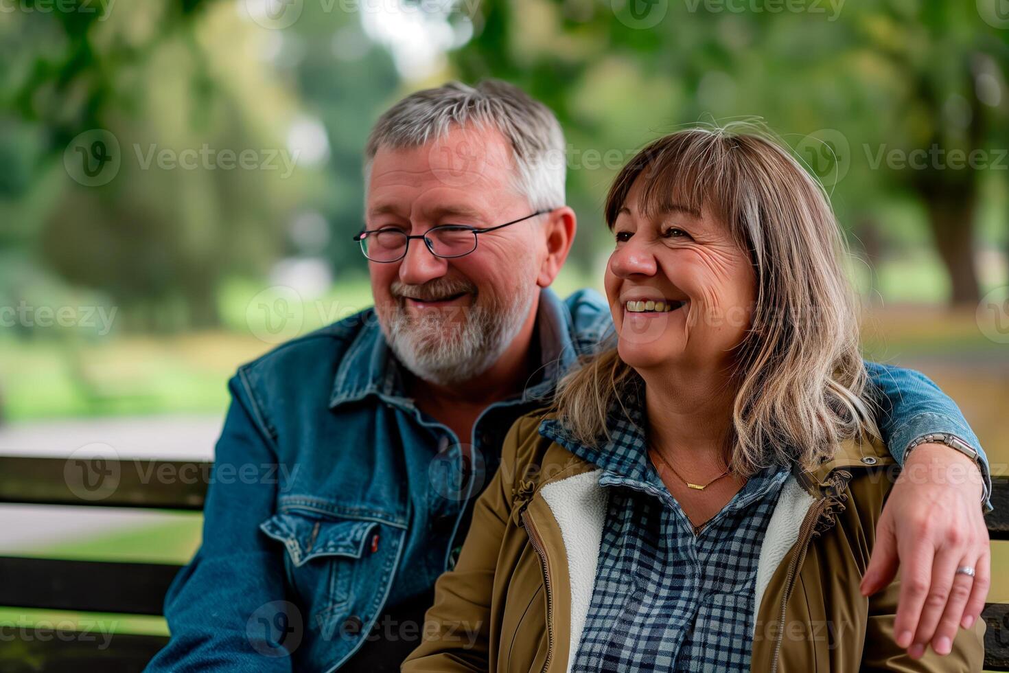 Happy elderly couple having a good time at the park. photo