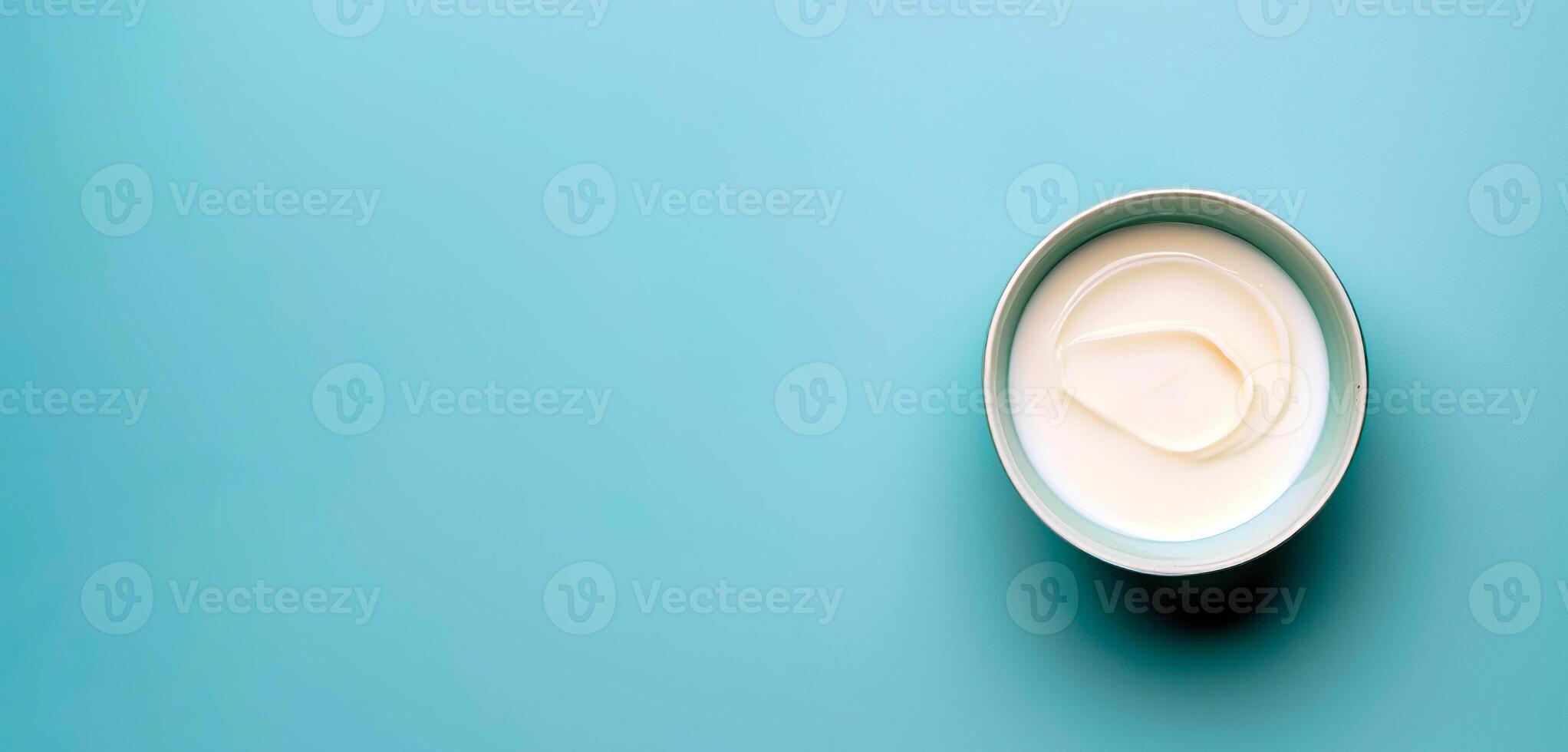 Bowl of sour cream isolated over blue background top view photo. photo
