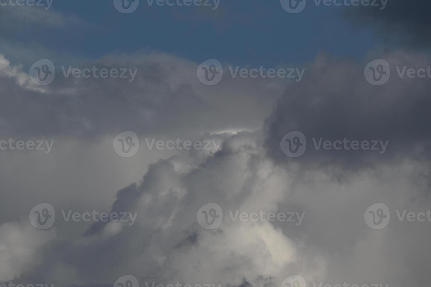 Cloudscape scenery, overcast weather above dark blue sky. Storm clouds floating in a rainy dull day with natural light. White and grey scenic environment background. Nature view. photo