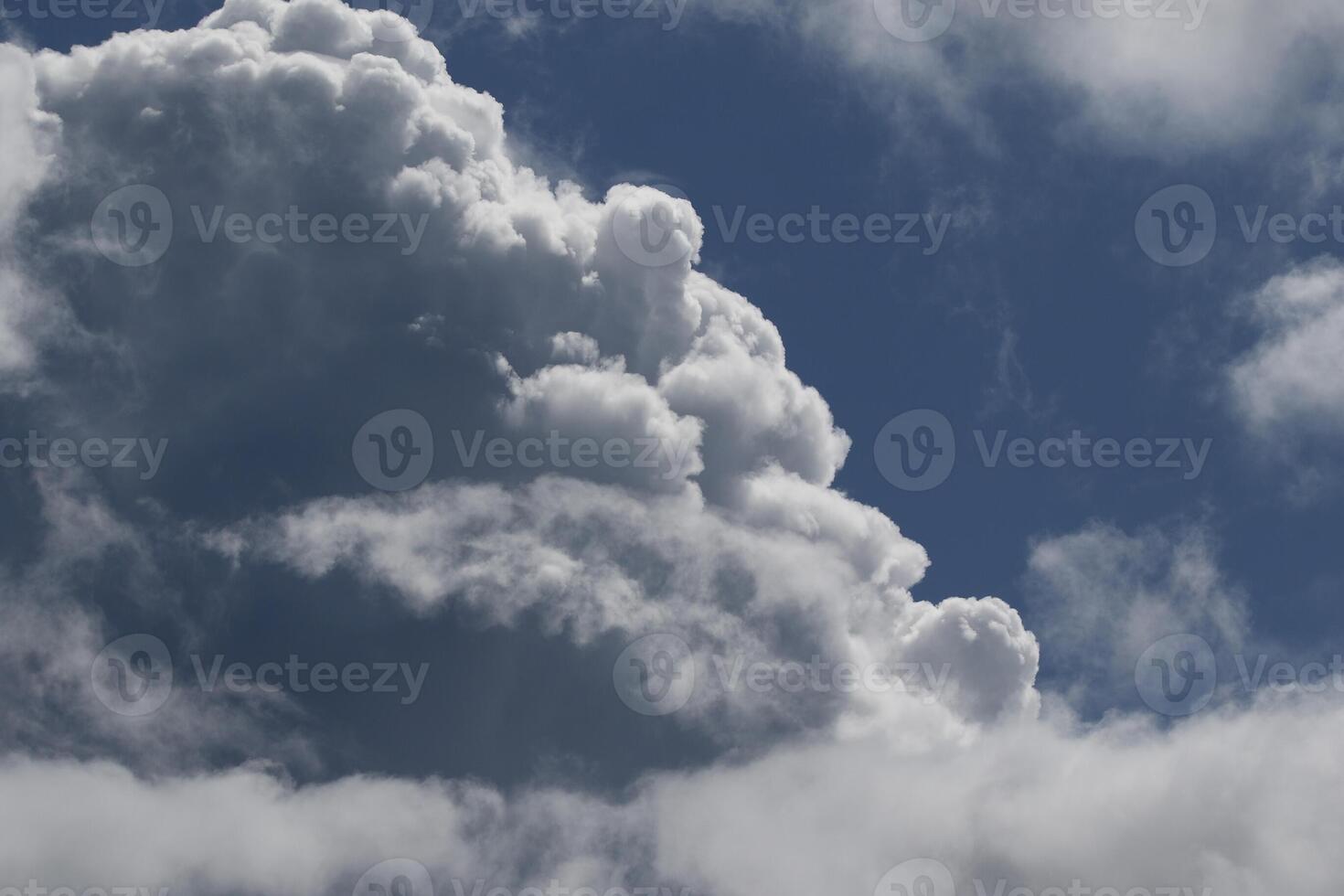 Cloudscape scenery, overcast weather above dark blue sky. Storm clouds floating in a rainy dull day with natural light. White and grey scenic environment background. Nature view. photo
