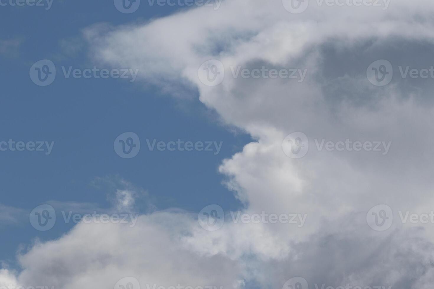 Cloudscape scenery, overcast weather above dark blue sky. Storm clouds floating in a rainy dull day with natural light. White and grey scenic environment background. Nature view. photo