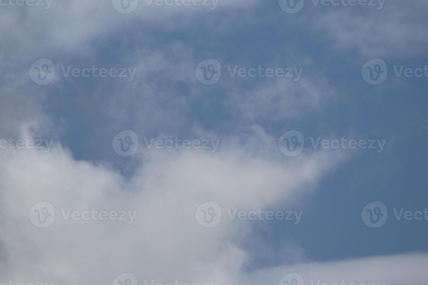 Cloudscape scenery, overcast weather above dark blue sky. Storm clouds floating in a rainy dull day with natural light. White and grey scenic environment background. Nature view. photo