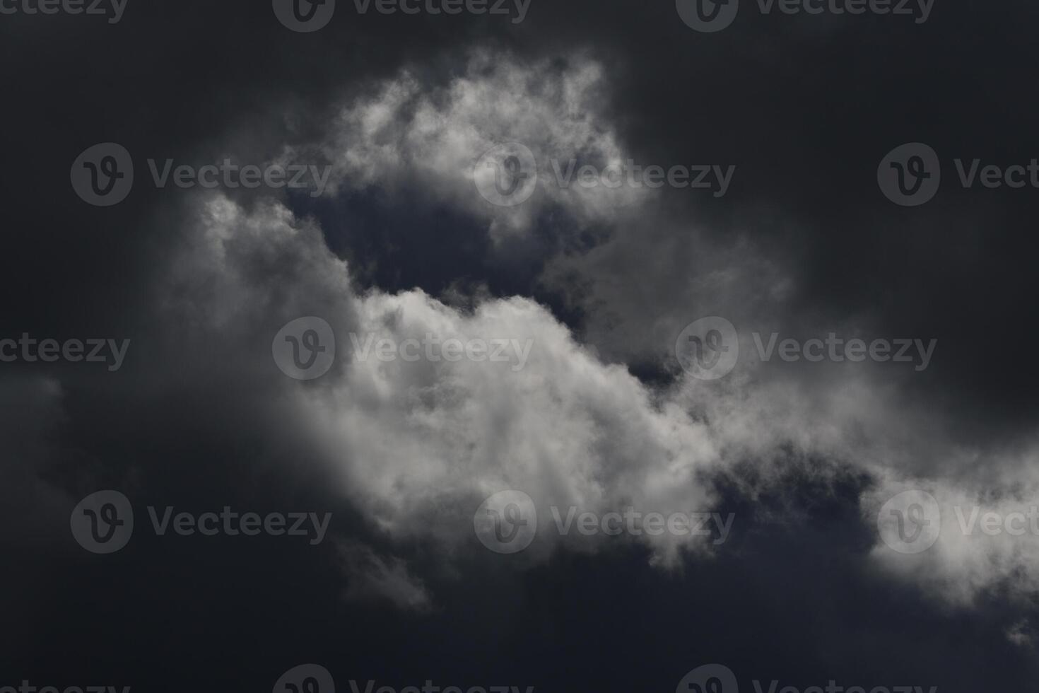 Cloudscape scenery, overcast weather above dark blue sky. Storm clouds floating in a rainy dull day with natural light. White and grey scenic environment background. Nature view. photo