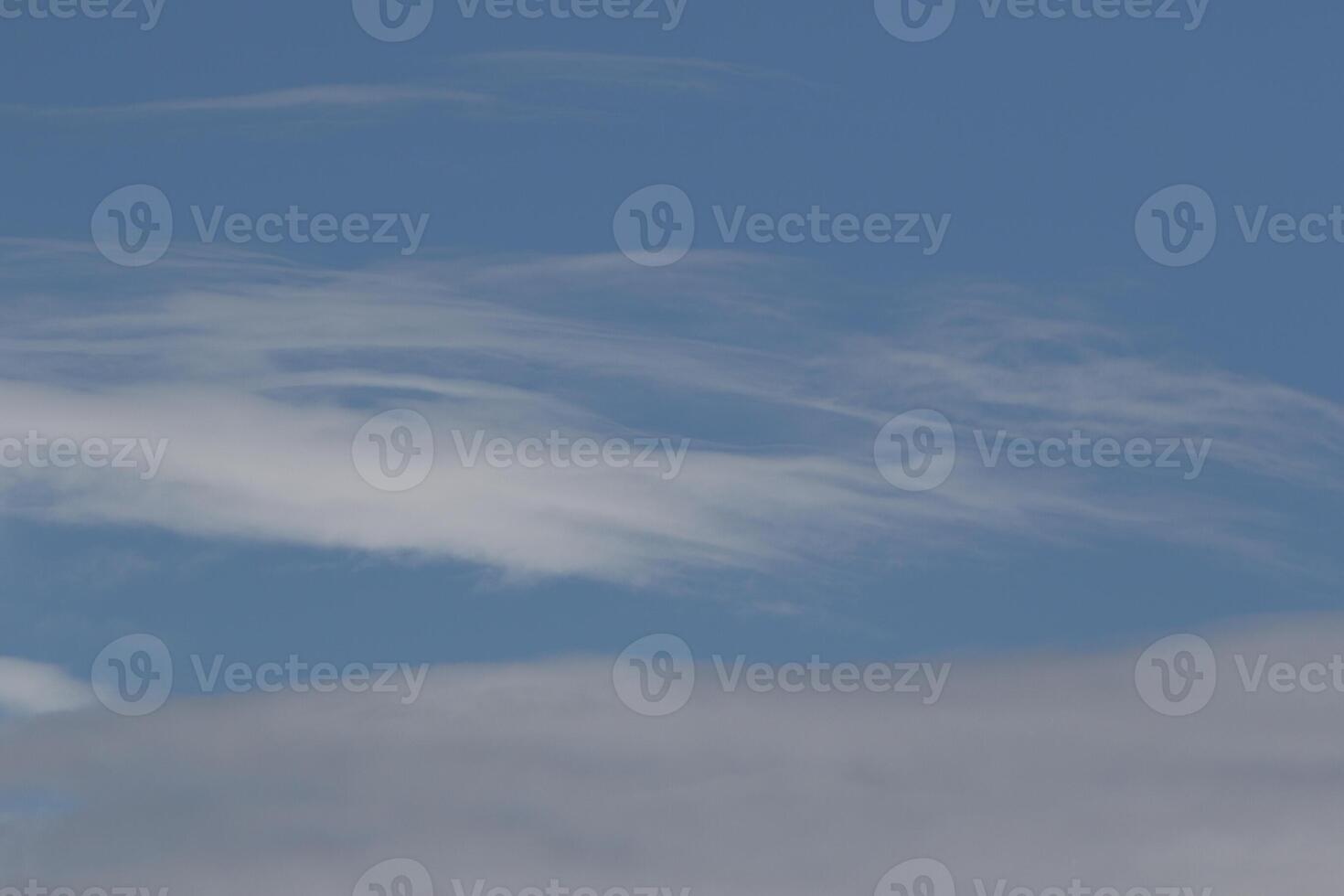 Cloudscape scenery, overcast weather above dark blue sky. Storm clouds floating in a rainy dull day with natural light. White and grey scenic environment background. Nature view. photo