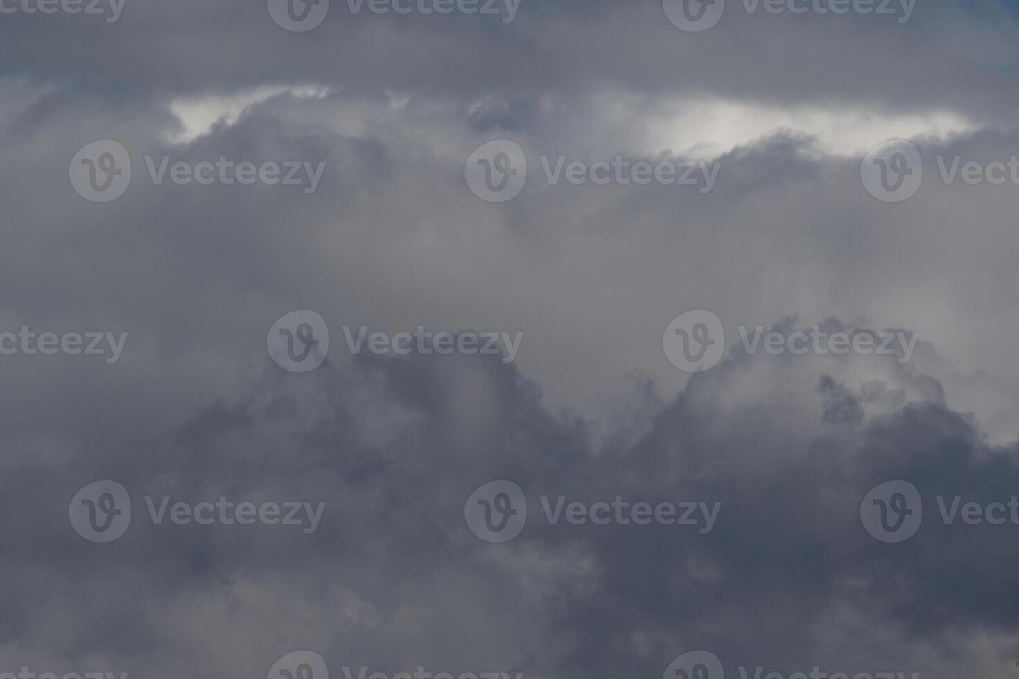 Cloudscape scenery, overcast weather above dark blue sky. Storm clouds floating in a rainy dull day with natural light. White and grey scenic environment background. Nature view. photo