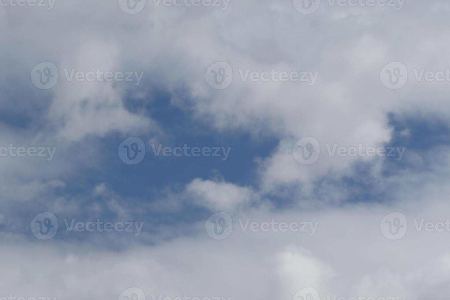 Cloudscape scenery, overcast weather above dark blue sky. Storm clouds floating in a rainy dull day with natural light. White and grey scenic environment background. Nature view. photo