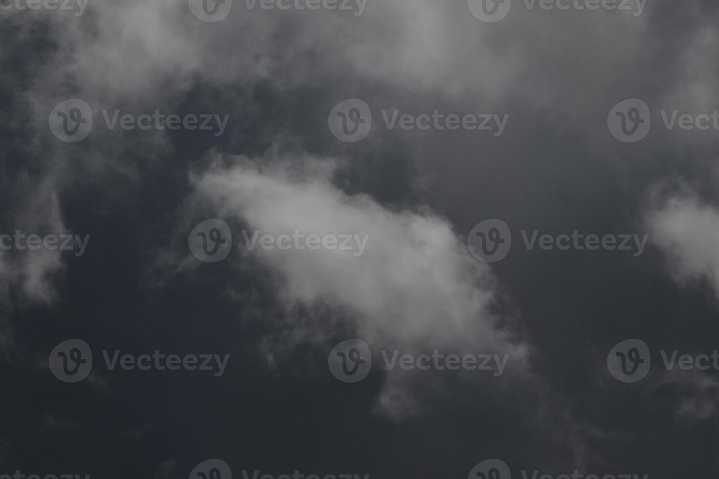 Cloudscape scenery, overcast weather above dark blue sky. Storm clouds floating in a rainy dull day with natural light. White and grey scenic environment background. Nature view. photo