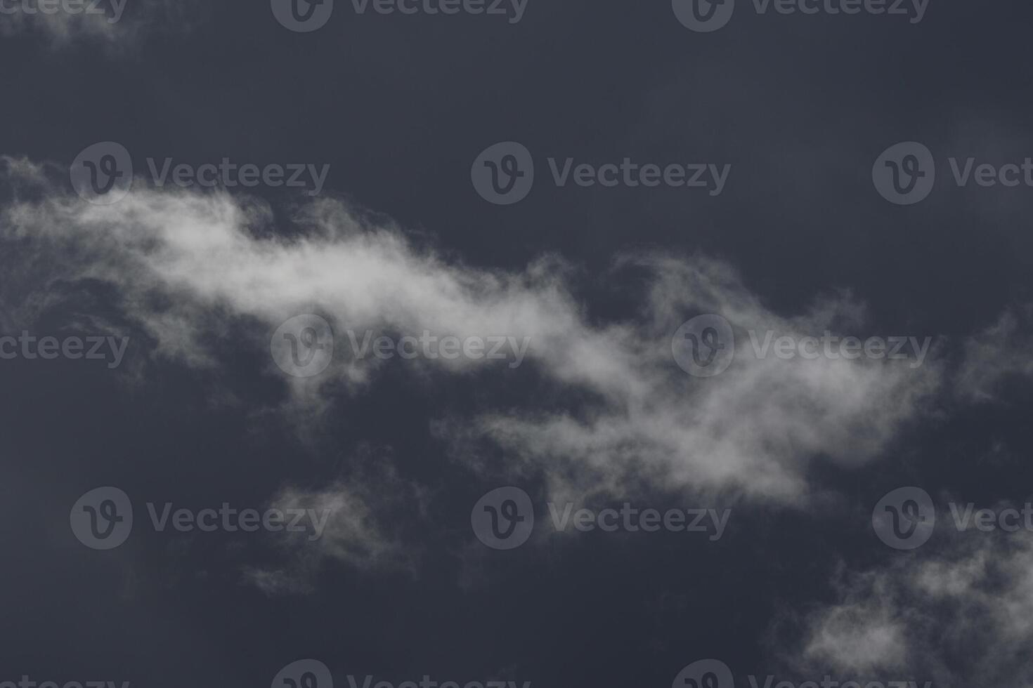 Cloudscape scenery, overcast weather above dark blue sky. Storm clouds floating in a rainy dull day with natural light. White and grey scenic environment background. Nature view. photo