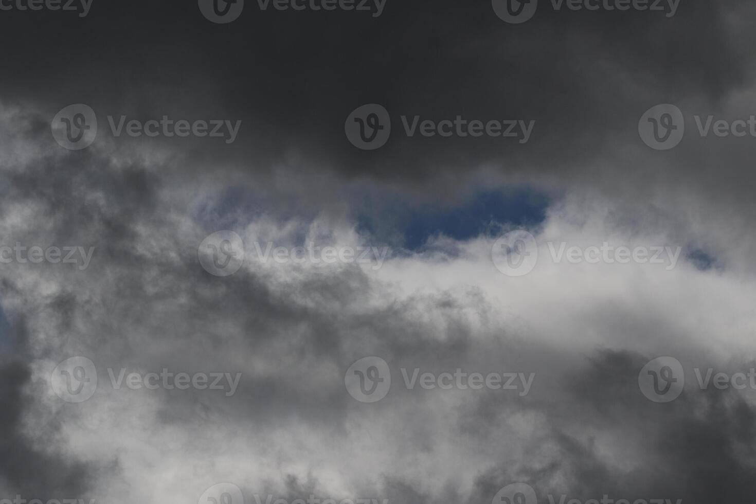 Cloudscape scenery, overcast weather above dark blue sky. Storm clouds floating in a rainy dull day with natural light. White and grey scenic environment background. Nature view. photo