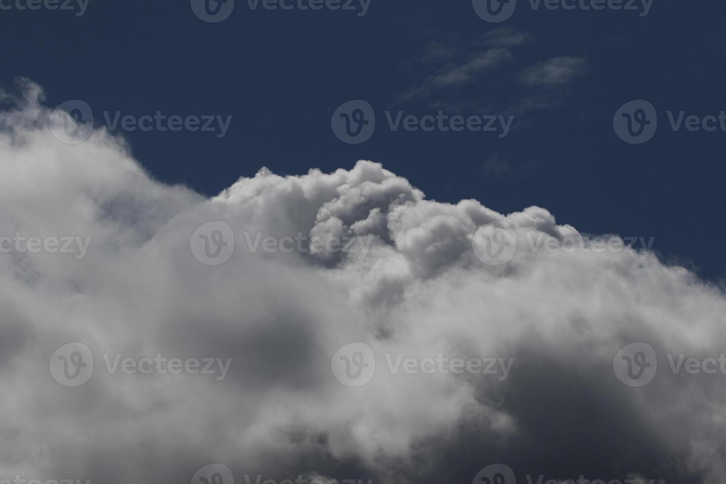 Cloudscape scenery, overcast weather above dark blue sky. Storm clouds floating in a rainy dull day with natural light. White and grey scenic environment background. Nature view. photo