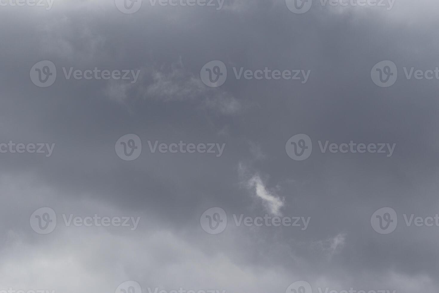 Cloudscape scenery, overcast weather above dark blue sky. Storm clouds floating in a rainy dull day with natural light. White and grey scenic environment background. Nature view. photo