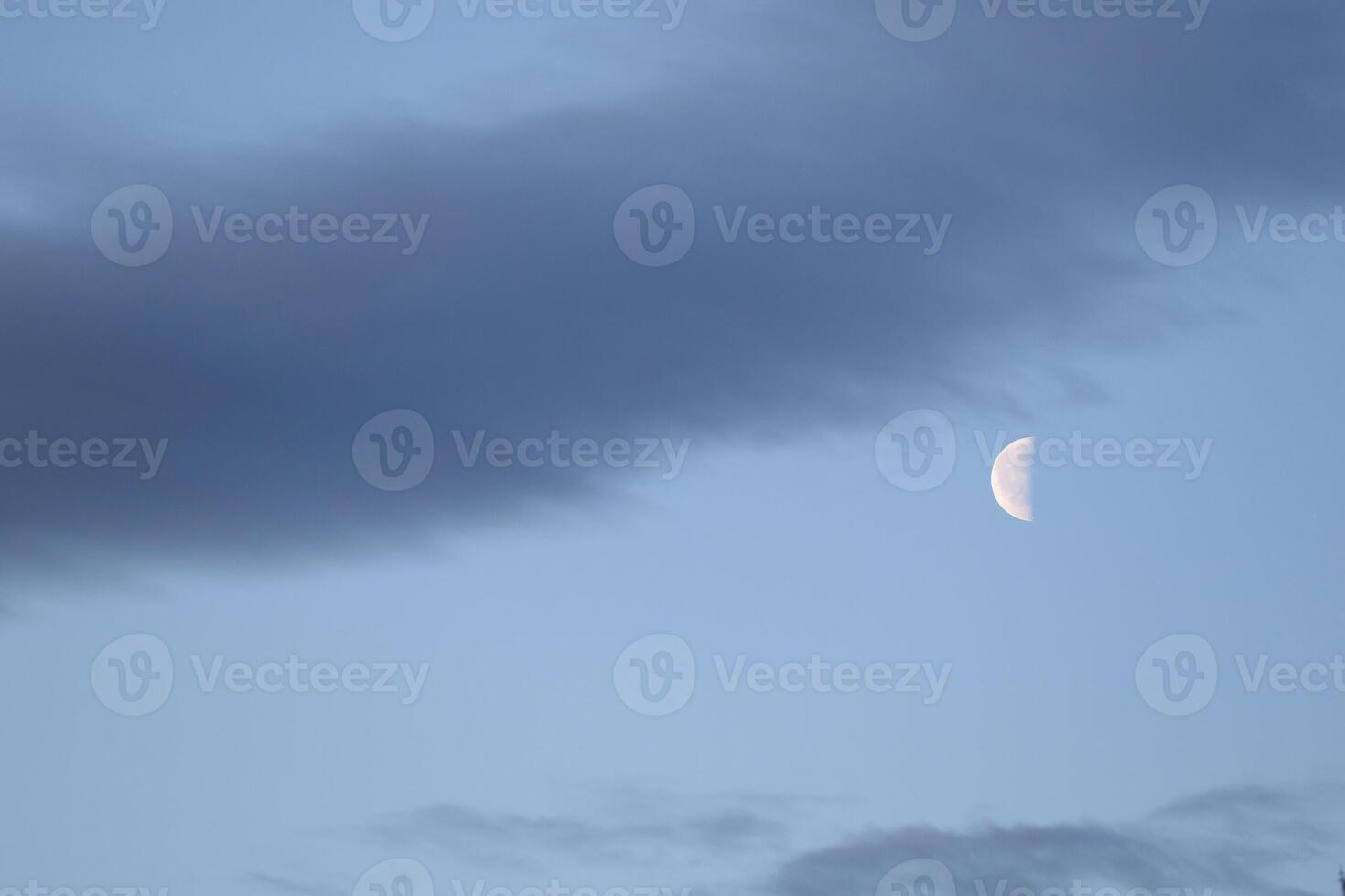 The colorful blue soft sky above the clouds with half moon photo