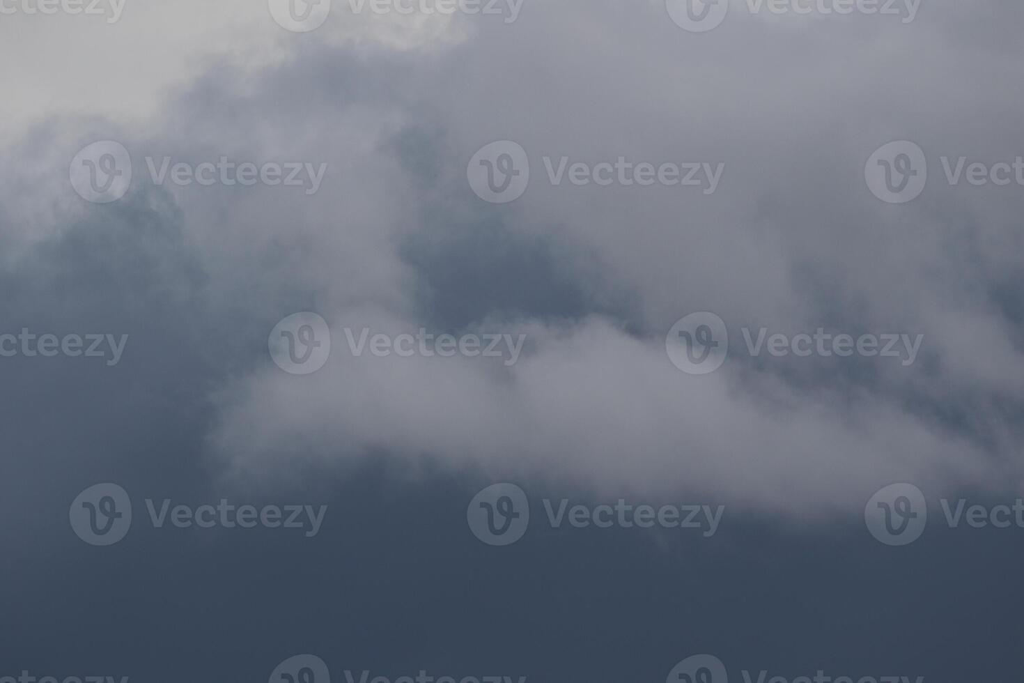 Cloudscape scenery, overcast weather above dark blue sky. Storm clouds floating in a rainy dull day with natural light. White and grey scenic environment background. Nature view. photo
