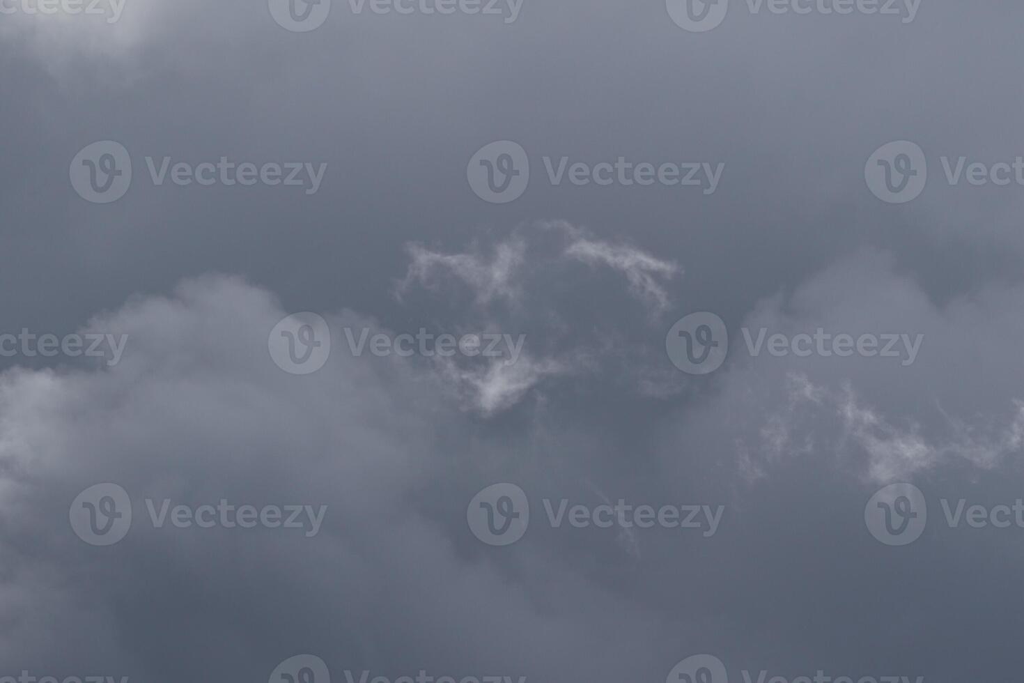 Cloudscape scenery, overcast weather above dark blue sky. Storm clouds floating in a rainy dull day with natural light. White and grey scenic environment background. Nature view. photo
