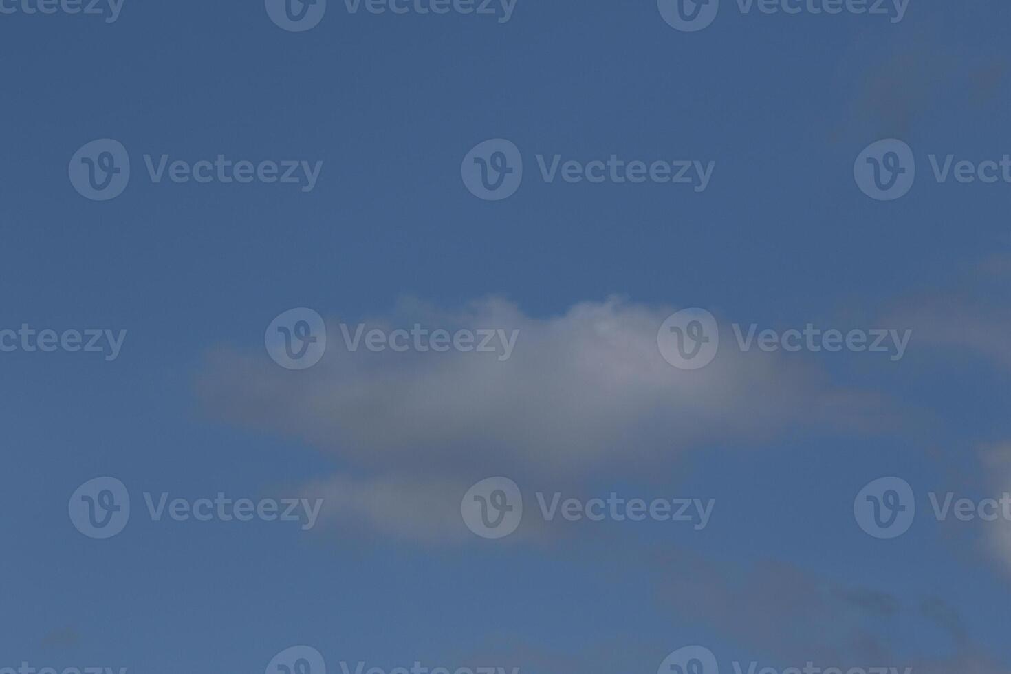 Cloudscape scenery, overcast weather above dark blue sky. Storm clouds floating in a rainy dull day with natural light. White and grey scenic environment background. Nature view. photo