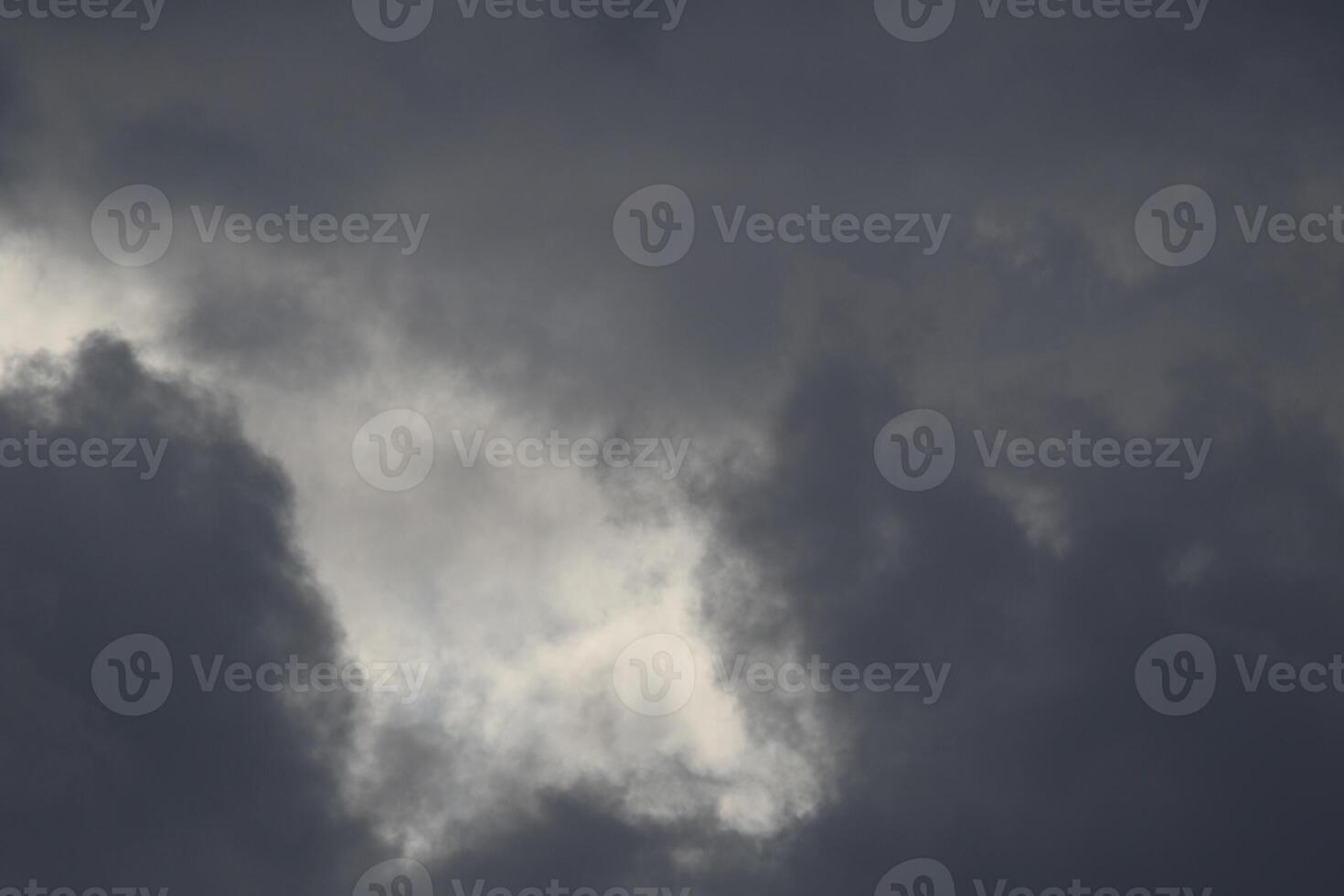 Cloudscape scenery, overcast weather above dark blue sky. Storm clouds floating in a rainy dull day with natural light. White and grey scenic environment background. Nature view. photo