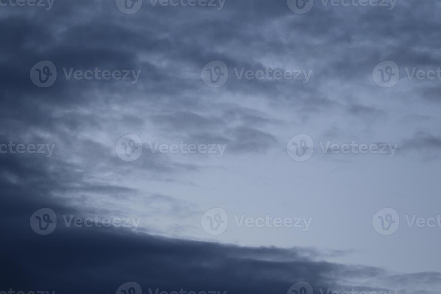 Cloudscape scenery, overcast weather above dark blue sky. Storm clouds floating in a rainy dull day with natural light. White and grey scenic environment background. Nature view. photo
