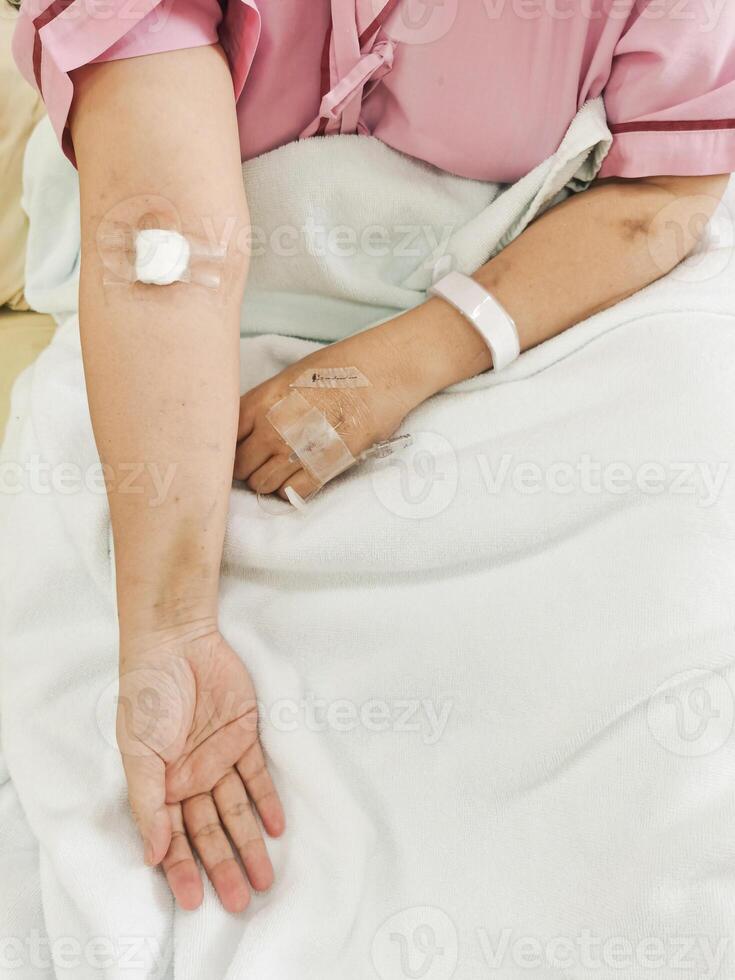 Arm of woman lying sick in hospital photo