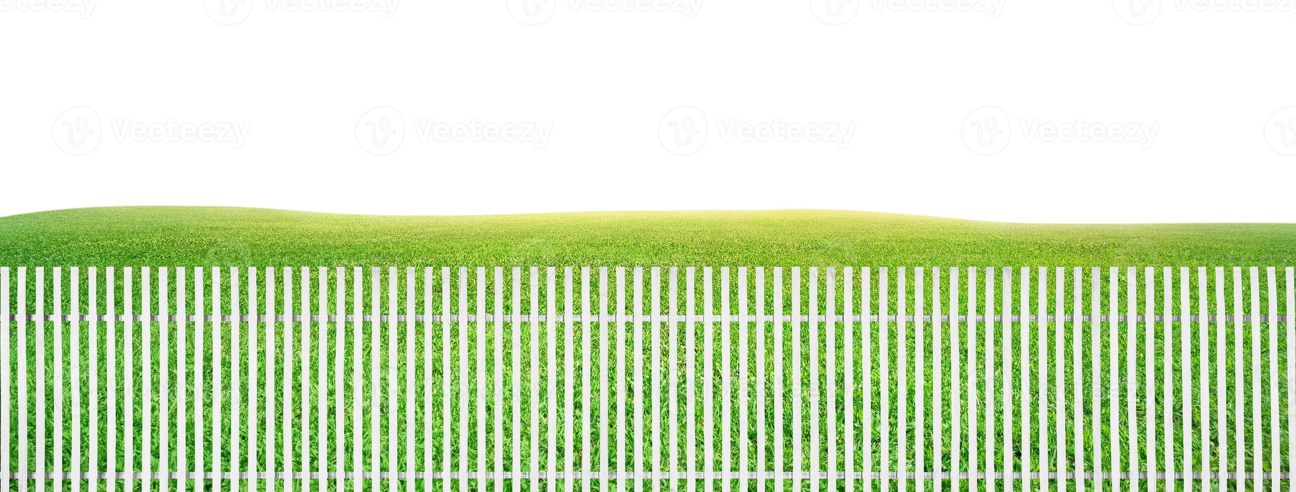 White wooden fence, green grass background photo