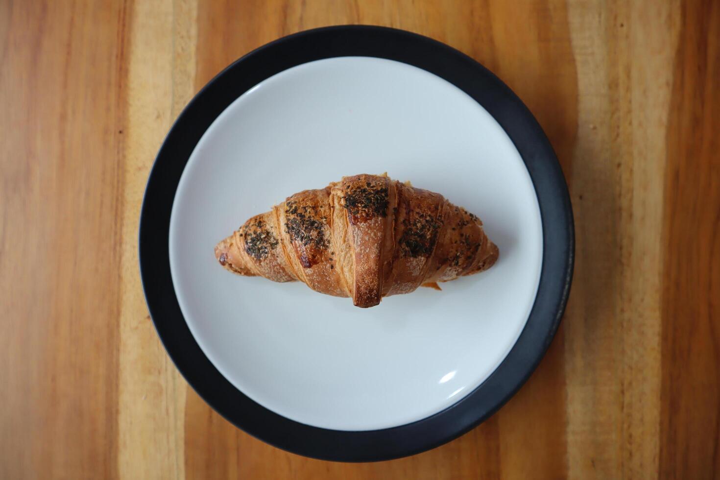 A plate of smoked beef croissants on the table background photo