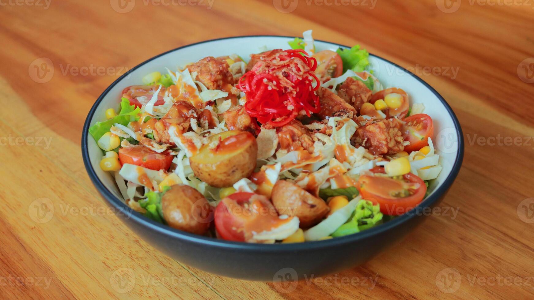 Top view of a bowl of gado-gado sprinkled with peanut sauce, suitable for seasoning satay, ketoprak, and others photo