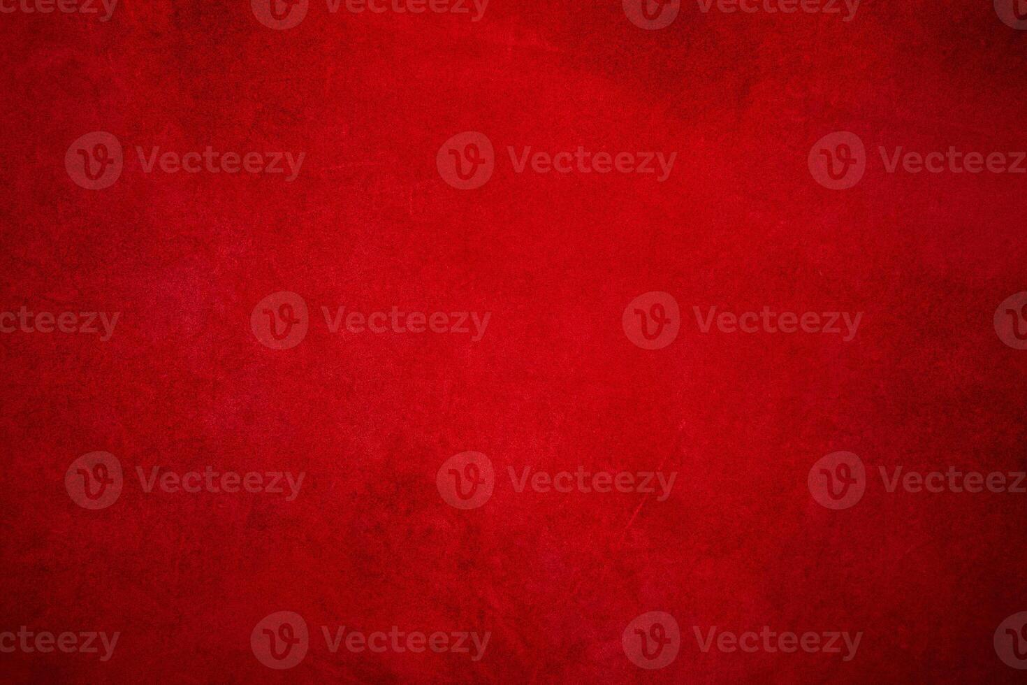 Suede background with small scratches, light red in the center and dark around the edges. photo