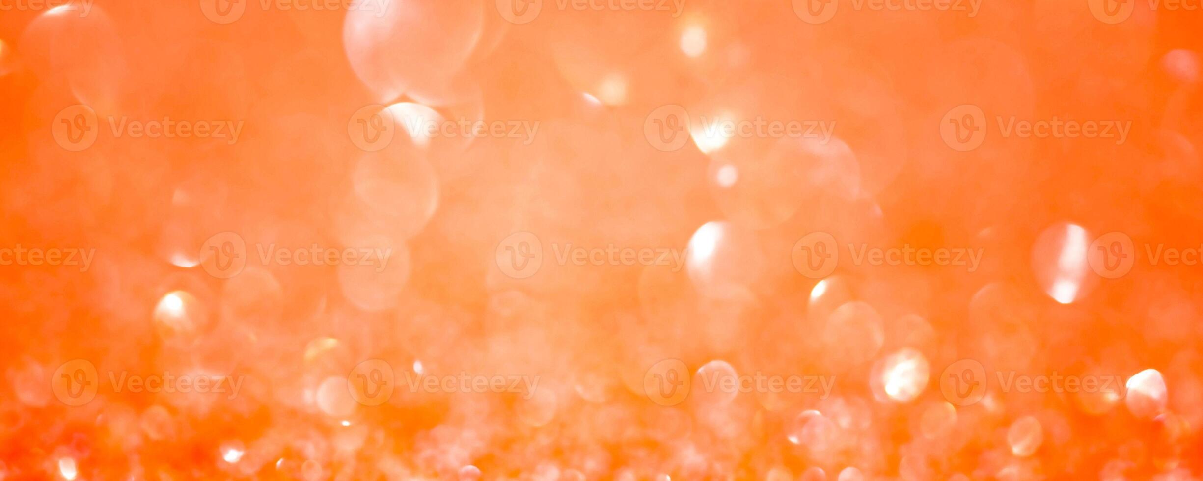 Sparkles defocus light. Orange background and yellow defocus. Background banner size. photo